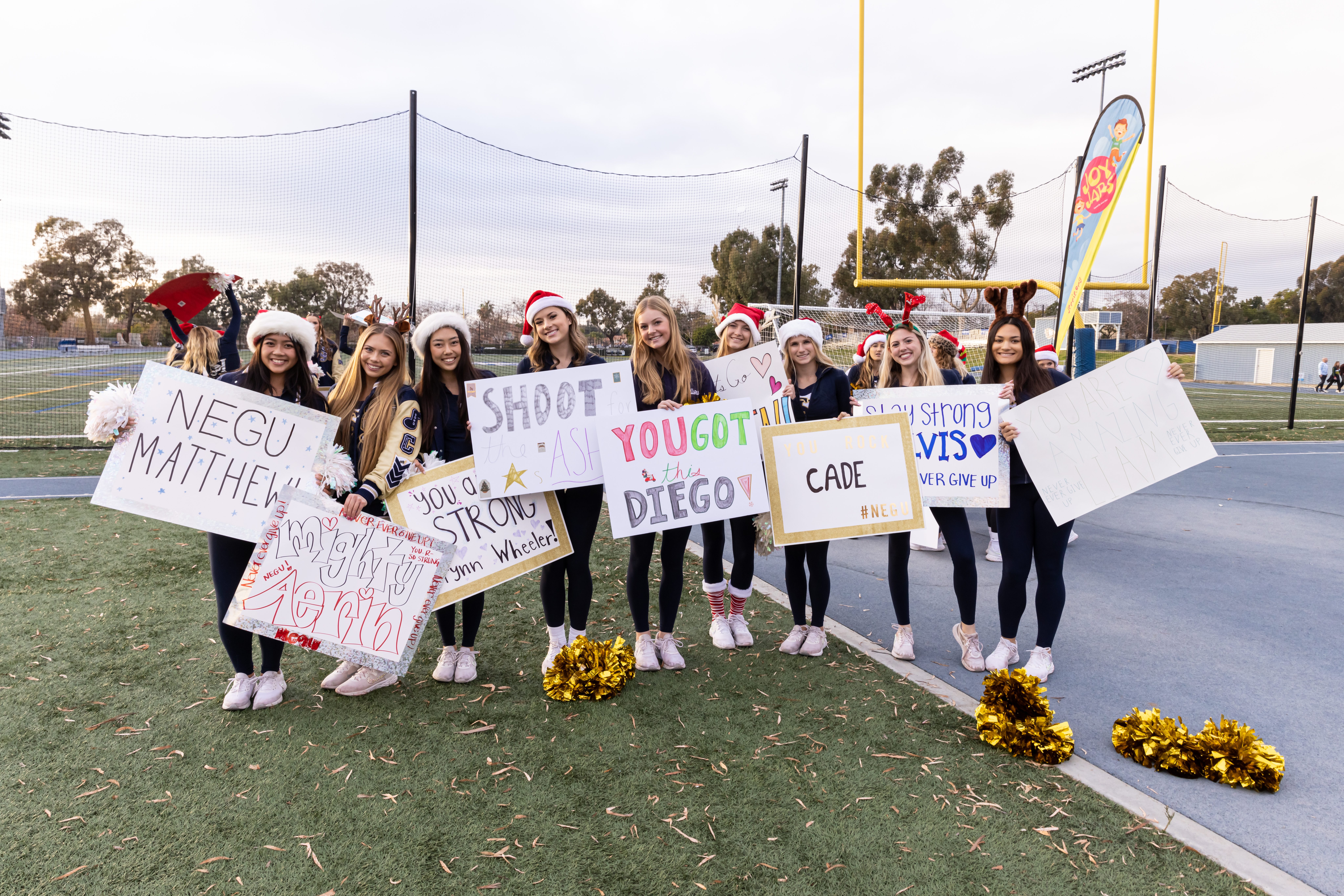 NCL ladies holding encouraging signs